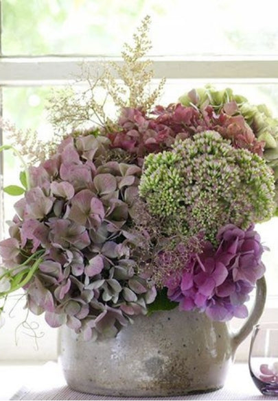 Vibrant Purple Florals in a Rustic Pot Greeting Card